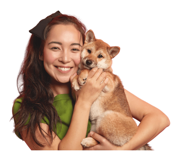Asian lady smiling at camera with her Akita puppy